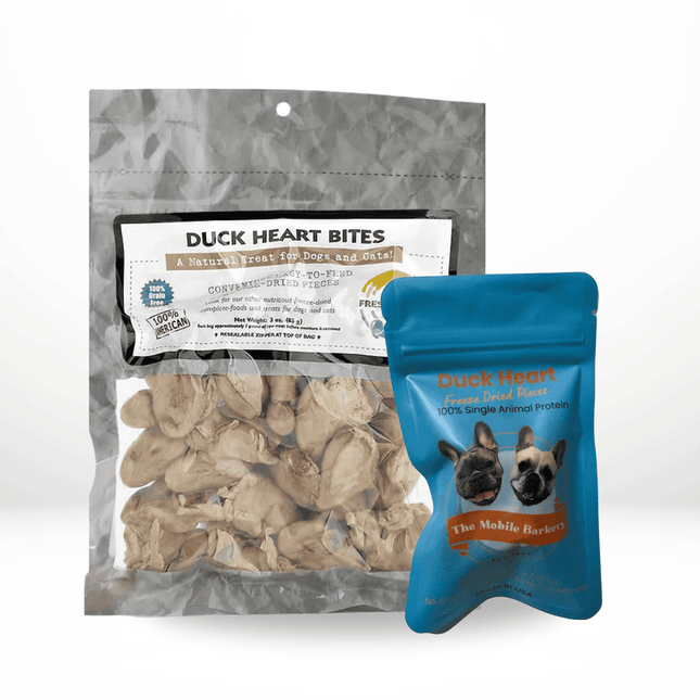 Two packages of duck heart dog treats, one silver resealable bag and one blue pouch from The Mobile Barkery.