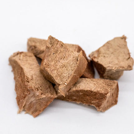 Close-up of freeze-dried beef heart chunks on a white background.