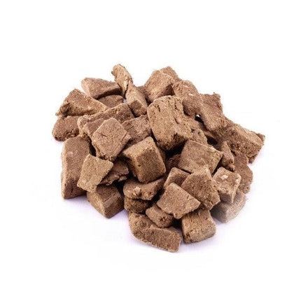 Pile of small freeze-dried venison cubes for dogs on a white background
