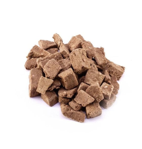Pile of small freeze-dried venison cubes for dogs on a white background