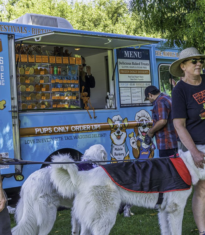Happy white dogs with guests at The Mobile Barkery treat truck