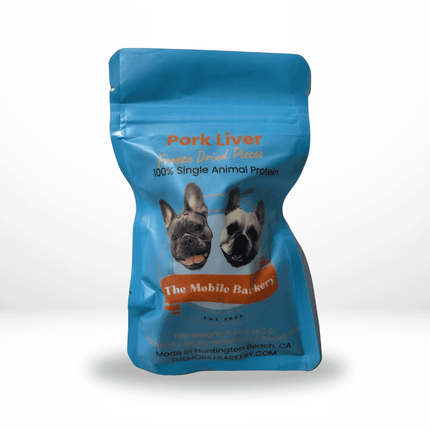 Blue pouch of freeze-dried pork liver dog treats from The Mobile Barkery, featuring two French bulldogs on the label.