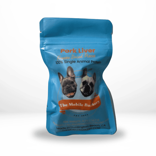 Blue pouch of freeze-dried pork liver dog treats from The Mobile Barkery, featuring two French bulldogs on the label.